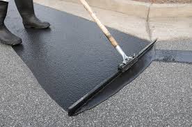 asphalt coating being applied