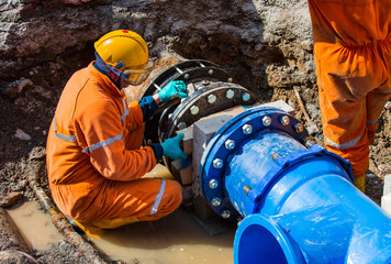 a construction worker installing a wet tap